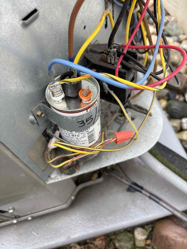 Completed annual cooling maintenance on 13-year-old Bryant system. Inspected and tested dual-run capacitor showing 35/5 MFD ratings, verified all electrical connections secure with proper wire terminations including ring terminals and wire caps. Confirmed system operational, updated best contact number to 517-712-0765, and documented equipment condition with photos of capacitor and electrical components.