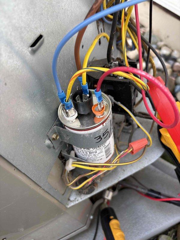 Completed annual cooling maintenance on 13-year-old Bryant system. Inspected and tested dual-run capacitor showing 35/5 MFD ratings, verified all electrical connections secure with proper wire terminations including ring terminals and wire caps. Confirmed system operational, updated best contact number to 517-712-0765, and documented equipment condition with photos of capacitor and electrical components.