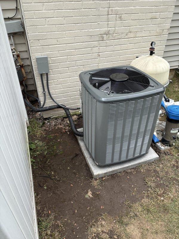 Completed full HVAC system installation including new furnace and air conditioning unit. Installed outdoor condensing unit on concrete pad with proper refrigerant lines, electrical disconnect, and conduit routing along exterior wall. Installed indoor furnace/air handler in basement with complete ductwork connections, PVC condensate drainage, and all necessary electrical components. System secured and operational pending final financing documentation completion.