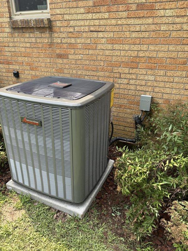 Completed full installation of new furnace and air conditioning system. Outdoor condensing unit was properly mounted on concrete pad with appropriate clearances from building structure, electrical disconnect box installed and wired per code requirements. System was positioned against brick exterior with proper refrigerant line connections, tested for operation, and confirmed all components functioning within manufacturer specifications.
