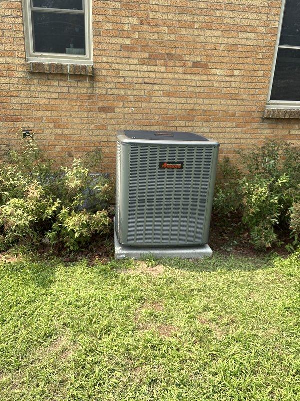 Completed full installation of new furnace and air conditioning system. Outdoor condensing unit was properly mounted on concrete pad with appropriate clearances from building structure, electrical disconnect box installed and wired per code requirements. System was positioned against brick exterior with proper refrigerant line connections, tested for operation, and confirmed all components functioning within manufacturer specifications.