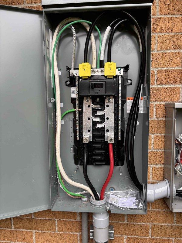 Completed 200-amp electrical service upgrade and subpanel installation on residential property. Coordinated utility disconnect and reconnect service to safely perform main service panel replacement. Installed new 200-amp main breaker panel with properly organized circuit breakers, bus bar assembly, and grounding system mounted on exterior brick wall. Routed service entrance conductors through metallic conduits from utility connection point to new meter base and main panel. Installed electrical disconnect box and completed all associated conduit work, including PVC ground-level runs. All wiring color-coded and secured per NEC standards with green grounding conductors, white neutrals, and black/red hot conductors properly terminated. Addressed client concerns regarding non-functioning outlets and clarified installation specifications for newly installed receptacles that appeared to protrude further than expected due to code-compliant box depth requirements. Obtained electrical permit and