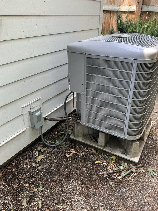 Responded to service call for air conditioning system with physical damage from fallen tree and cooling performance issues. Upon inspection, found outdoor condensing unit sustained minor dent to cabinet but remained operational. Diagnosed slow refrigerant leak in suction line causing low system charge and frozen evaporator coil. System comprised 2007 evaporator coil paired with 2012 heat pump unit. 

Performed temporary repair to restore immediate cooling functionality prior to customer travel. Provided estimate for complete 4-ton system replacement to be scheduled upon customer's return. Documented equipment condition with interior and exterior photographs showing basement HVAC installation and outdoor condensing unit placement. Customer elected to proceed with temporary repair and full system replacement at later date.