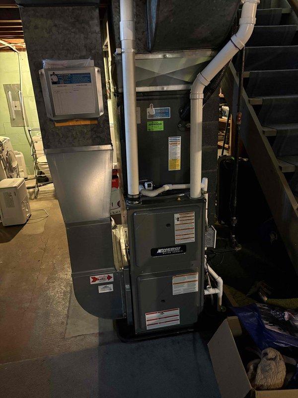 Responded to service call for 9-year-old air conditioning system with inside fan operational but outside unit not running, resulting in airflow without cooling. Performed diagnostic inspection of HVAC system including furnace and air handler unit located in basement installation. Documented equipment serial numbers and model information for service records. Identified issue preventing outdoor condensing unit from engaging while indoor blower motor continued operation, causing system to circulate unconditioned air through ductwork without refrigeration cycle activation.