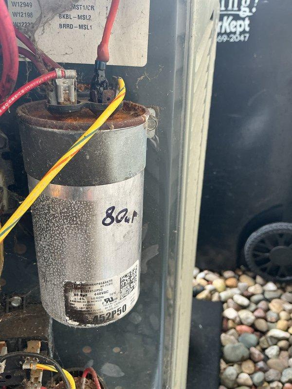 Completed annual cooling maintenance on 13-year-old Trane system. Inspected outdoor condensing unit, photographed and documented capacitor condition showing 80μF dual run capacitor with visible wear and weathering but functioning within specifications. Verified all electrical connections secure with proper wire terminations on capacitor terminals, checked control panel components, and confirmed unit operational status for continued service.