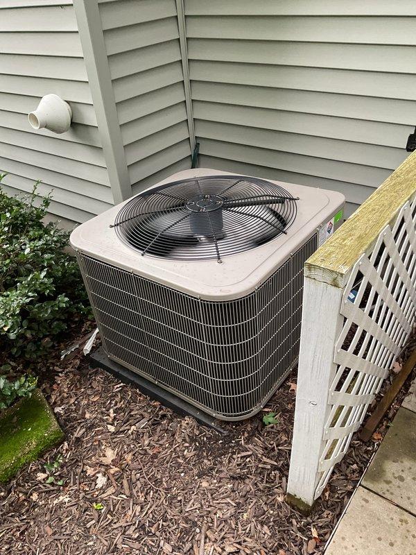 Responded to cooling complaint on 15-year-old Carrier system that was not maintaining temperature setpoint. Unit had previously received approximately 4 pounds of refrigerant and dye during tune-up service in June. Performed diagnostic evaluation of outdoor condenser unit and indoor air handler system. Inspected condenser coil condition, verified electrical connections, and checked refrigerant pressures. System evaluation revealed continued refrigerant loss since previous service visit when dye was added to aid in leak detection. Located active refrigerant leak using UV light inspection of previously injected dye. Recovered remaining refrigerant from system per EPA regulations. Performed necessary leak repair and pressure tested system to verify integrity. Evacuated system to proper vacuum levels and recharged with manufacturer-specified refrigerant quantity. Verified proper system operation including temperature split, amperage draw, and cycling behavior. Unit operating within normal 