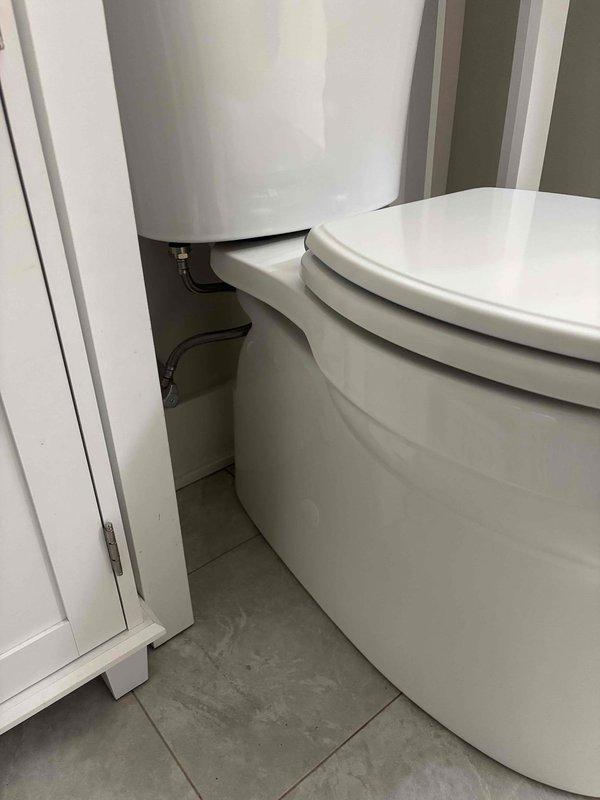 Completed comprehensive main floor bathroom repair assessment and documentation. Inspected and photographed all plumbing fixtures, cabinetry, and finishes including toilet installation, water heater access, vanity with undermount sink, dual-handle faucet assembly, and granite composite countertop. All fixtures evaluated for condition and functionality with photographic documentation provided for repair estimates.