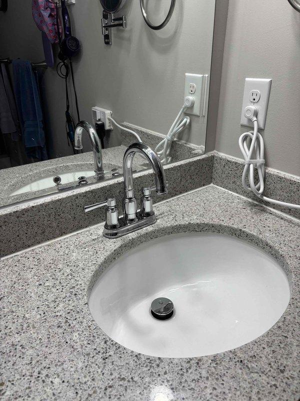 Completed comprehensive main floor bathroom repair assessment and documentation. Inspected and photographed all plumbing fixtures, cabinetry, and finishes including toilet installation, water heater access, vanity with undermount sink, dual-handle faucet assembly, and granite composite countertop. All fixtures evaluated for condition and functionality with photographic documentation provided for repair estimates.