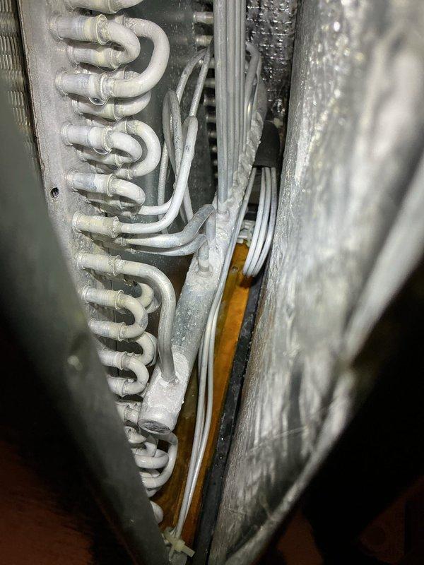 Completed annual cooling maintenance on 2018 EnergiAir system. Performed comprehensive inspection of evaporator coil assembly, noting normal operational wear and minor dust accumulation on refrigerant tubes. Verified system components including air handler cabinet, ductwork connections, and electrical wiring. Conducted diagnostic testing using electronic measurement tools to assess system performance and refrigerant levels, with all readings indicating proper operation. Updated customer contact information and documented equipment condition with photographic records for service history.