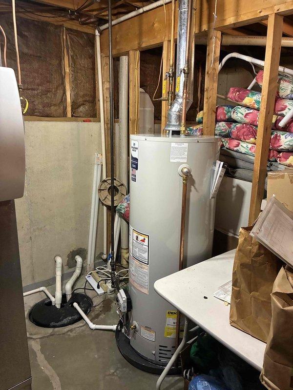 Completed warranty replacement of residential gas water heater with Bradford White RG250T6N model in basement utility area. Removed existing failed unit and installed new 50-gallon atmospheric vent gas water heater. Connected gas supply line, cold water inlet, and hot water outlet piping. Installed proper venting system with metal vent pipe. Verified all connections for leaks, tested gas valve operation, and confirmed proper ignition sequence. Unit operational and heating water as designed upon completion.