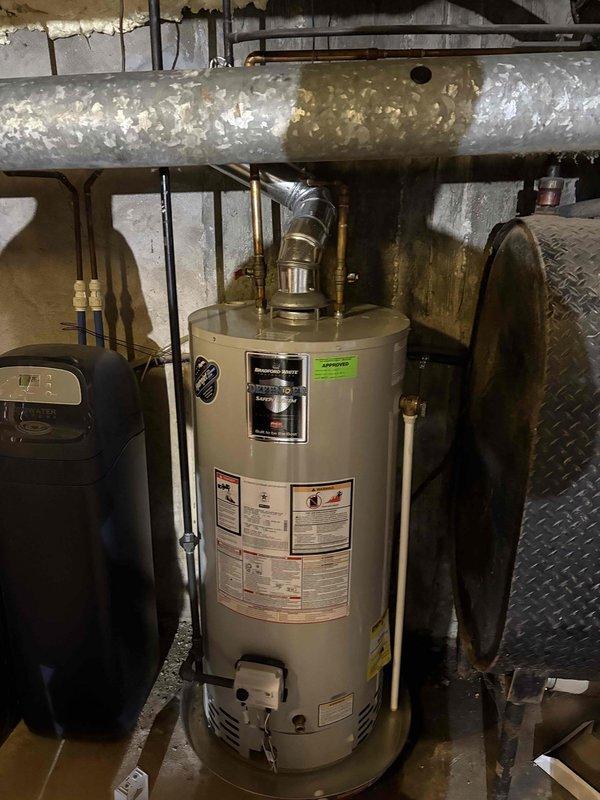 Responded to emergency water leak at residential property where water heater was actively leaking from top connections. Upon arrival, confirmed 6-year-old Bradford White water heater with fast leak originating from upper plumbing connections. Advised homeowner to cease water usage to minimize water damage while assessment was conducted. Documented equipment condition, manufacturer specifications, and leak source with photographic evidence showing copper supply lines, brass fittings, and vent connections at top of unit. Water heater warranty expires 08-10-2026. Provided customer with contact information for follow-up service coordination.