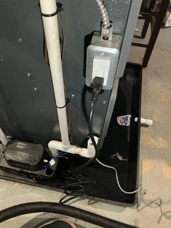 Responded to water leak service call where water was observed in drain pan and unit was not operational. Upon arrival, inspected HVAC system and drainage components. Used inspection camera to examine interior ductwork and metal ventilation components, identifying dust accumulation on surfaces. Evaluated condensate drain line routing, PVC piping connections, and electrical components mounted to equipment cabinet. Inspected drain pan for proper drainage, checked condensate pump operation if applicable, and verified all drain line connections were secure. Examined electrical box connections and wiring integrity. System had been shut down prior to arrival as precautionary measure. Documented conditions with photos of internal ductwork and external equipment configuration including drain lines, electrical components, and associated hardware.