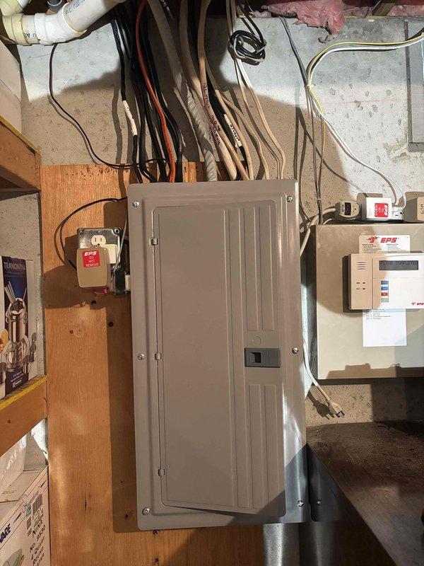 Completed 150-amp electrical service upgrade including installation of new main breaker panel, exterior emergency disconnect switch, and associated metering equipment. Coordinated utility disconnect and reconnect services, obtained electrical permit, and passed final inspection. Installed gray breaker panel on wooden backing in basement utility area with proper cable routing, mounted Siemens-branded exterior emergency disconnect on building exterior with weather-resistant enclosures, and integrated digital monitoring controller for system management.