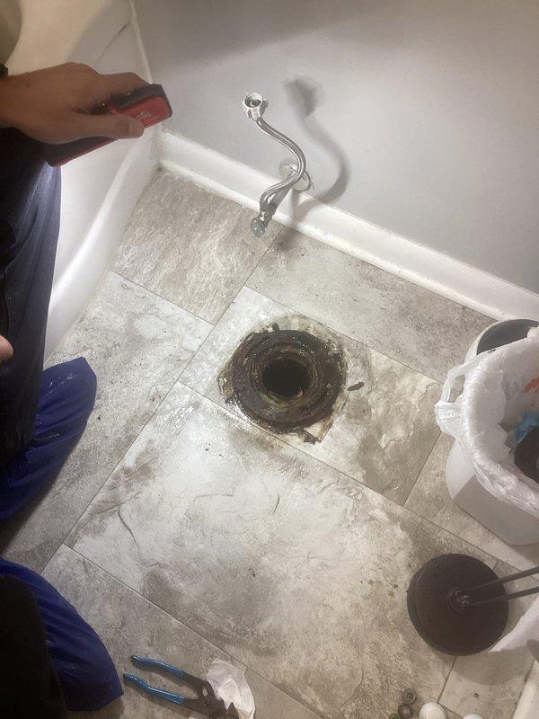 Completed plumbing project involving concrete breaking to access drainage system. Removed existing toilet flange and exposed drain opening to install new crock basin. Installed new sump pump system to manage water drainage. Work included floor preparation, proper sealing of new crock installation, and connection of pump discharge lines to ensure effective water removal from the basement level.