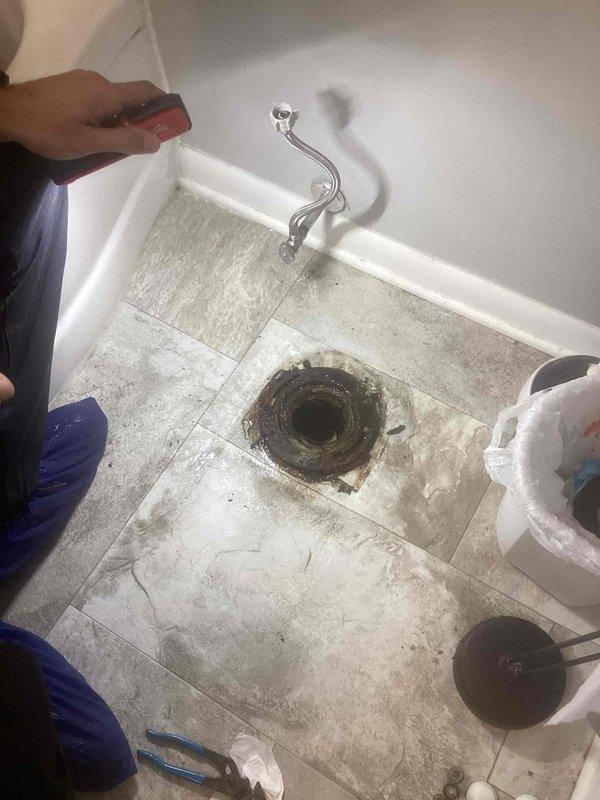 Completed plumbing project involving concrete breaking to access drainage system. Removed existing toilet flange and exposed drain opening to install new crock basin. Installed new sump pump system to manage water drainage. Work included floor preparation, proper sealing of new crock installation, and connection of pump discharge lines to ensure effective water removal from the basement level.
