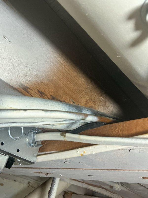 Completed annual cooling maintenance on approximately 5-year-old Lennox system. Replaced heavily soiled air filter that was completely saturated with dust and debris accumulation, significantly restricting airflow. Documented rust-colored staining on ceiling surfaces near utility piping, indicating previous moisture intrusion in area. Performed standard AC tune-up procedures and system operational check. Unit operating properly following filter replacement and maintenance completion.