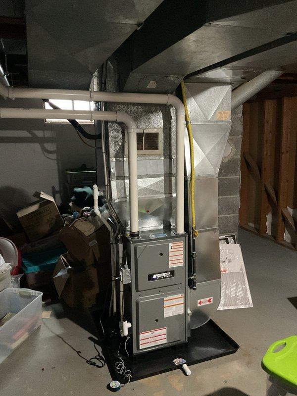 Responded to no-cooling call on 22-year-old residential AC system. Upon arrival, confirmed water accumulation in drain pan and system shutdown as previously advised. Performed comprehensive diagnostic evaluation of both indoor air handler and outdoor condensing unit. Assessed furnace/air handler installation in basement mechanical room, inspecting PVC condensate drain lines, evaporator coil condition, and blower assembly. Evaluated exterior condenser unit for mechanical and electrical functionality, checking refrigerant pressures, compressor operation, and fan motor performance. Documented equipment age and overall system condition through photographic evidence. Provided detailed estimate for necessary repairs to restore cooling operation versus replacement options given the advanced age of the existing HVAC system.