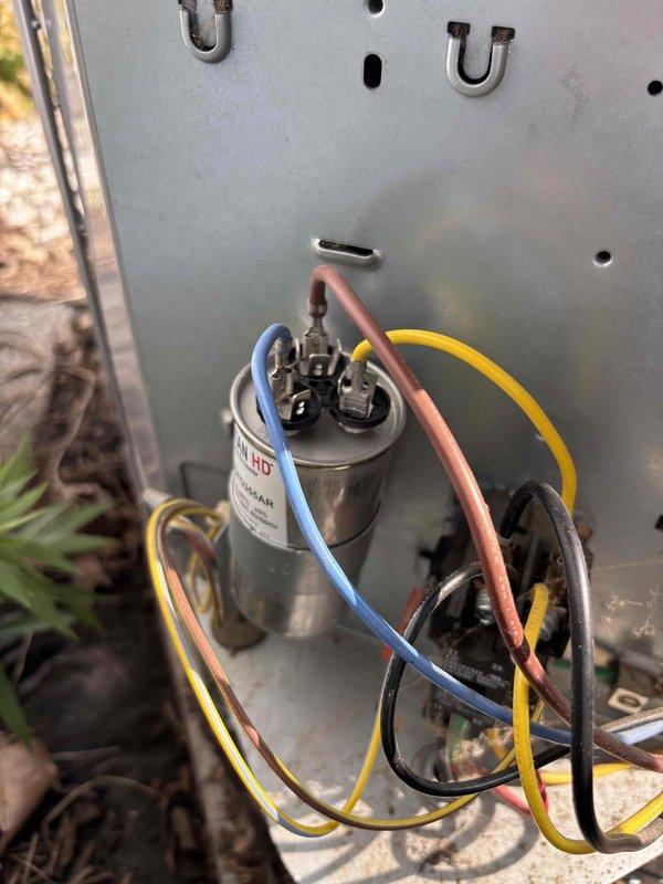 # AC No Cooling - Capacitor Replacement

Responded to service call for air conditioning unit shutting off with buzzing sound and no cold air production. Upon inspection, identified failed TITAN capacitor as root cause of system malfunction. Capacitor showed signs of electrical failure consistent with reported buzzing noise and compressor startup issues. Replaced defective capacitor with new unit matching original specifications. Verified all electrical connections secure and properly terminated. Tested system operation through complete cooling cycle. Unit now running normally with proper compressor startup, no abnormal sounds, and cold air delivery restored. System returned to full operational status.