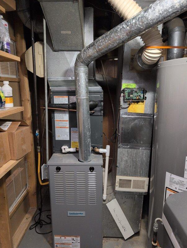 Completed full air conditioning system replacement at residential property. Installed new outdoor condensing unit on existing concrete pad with proper electrical disconnect and conduit connections to exterior wall. Connected indoor air handler to existing furnace system with appropriate ductwork integration including flexible and rigid metal ducting with insulation. Verified all electrical connections, refrigerant lines, and condensate drainage were properly installed and secured. System startup performed with successful operational testing of all components.