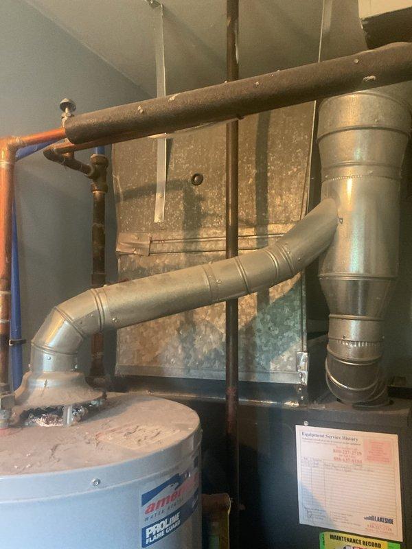 Responded to service call for water heater leaking at bottom. Upon inspection, found existing American brand water heater with visible deterioration and active leak at base of unit. Documented current condition showing aged equipment with compromised tank integrity. Provided estimate for complete water heater replacement, including removal of failed unit and installation of new equipment with appropriate connections and code-compliant installation.