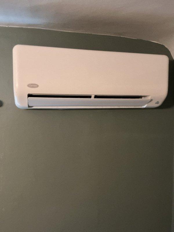 Responded to service call for wall-mounted ductless mini-split system experiencing recurring refrigerant line freezing. Upon arrival, observed ice accumulation on refrigerant lines that would temporarily thaw but quickly re-freeze during operation. Based on system history of similar issues previously resolved by refrigerant recharge, performed diagnostic evaluation of the unit. Checked refrigerant charge levels, identified low refrigerant condition causing inadequate pressure and subsequent line freezing. Recharged system to manufacturer specifications, verified proper operation, and confirmed resolution of freezing issue. Unit returned to normal cooling operation with proper airflow and temperature differential.