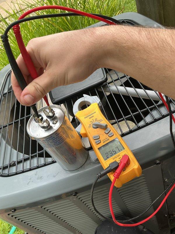 Completed annual cooling maintenance on Energi Air Systems Elite Series HVAC unit. Performed comprehensive system inspection, tested capacitor voltage reading at 235.1V, and evaluated overall unit operation. Observed dirt and debris accumulation on internal components behind ventilation louvers; unit remains operational with all electrical components testing within normal parameters.