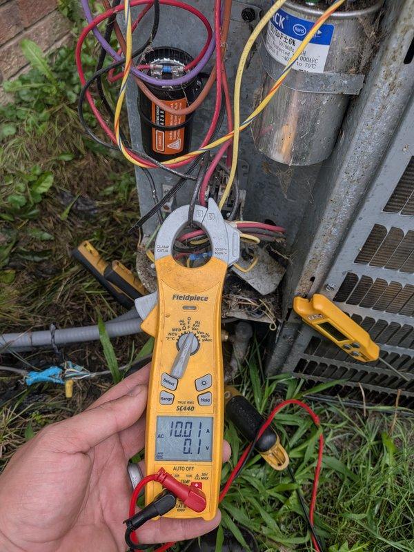 Responded to service call for 9-year-old air conditioning unit with reported fan blade and motor issues from previous homeowner. Upon arrival, performed diagnostic testing of outdoor condenser unit using clamp meter to measure electrical current and verify component operation. Inspected condenser fan motor, capacitor, and compressor assembly. Found capacitor with proper connections and tested electrical loads on system components. Verified all wiring connections to motor and capacitor were secure. Unit operational at time of inspection with readings within normal parameters. Addressed concerns regarding fan motor performance and completed system evaluation.