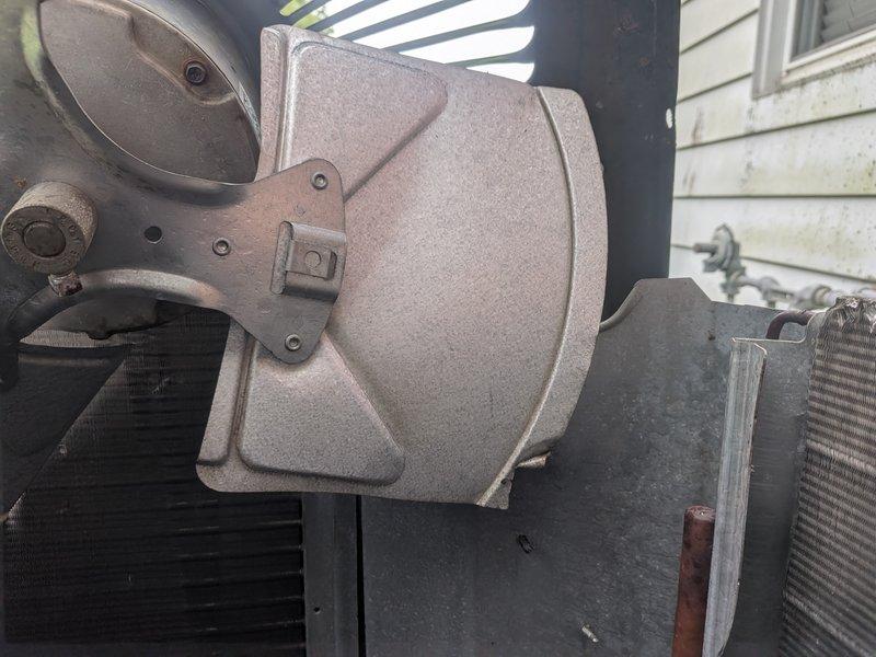 Responded to service call for 9-year-old air conditioning unit with reported fan blade and motor issues from previous homeowner. Upon arrival, performed diagnostic testing of outdoor condenser unit using clamp meter to measure electrical current and verify component operation. Inspected condenser fan motor, capacitor, and compressor assembly. Found capacitor with proper connections and tested electrical loads on system components. Verified all wiring connections to motor and capacitor were secure. Unit operational at time of inspection with readings within normal parameters. Addressed concerns regarding fan motor performance and completed system evaluation.