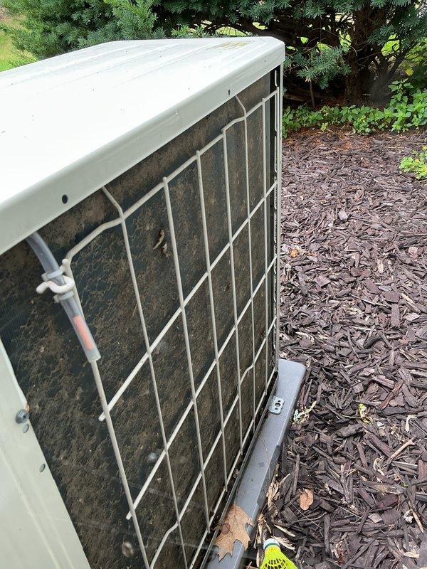 Completed annual cooling system maintenance and inspection on residential outdoor condensing unit. Upon arrival, found significant dirt and debris accumulation on condenser coils and intake surfaces. Performed thorough cleaning of condenser coils, removed organic matter and dust buildup from fins and grille areas. Inspected unit operation, verified proper airflow through heat exchanger, and confirmed system functionality. Unit returned to normal operating condition with improved heat transfer efficiency following coil cleaning and maintenance procedures.