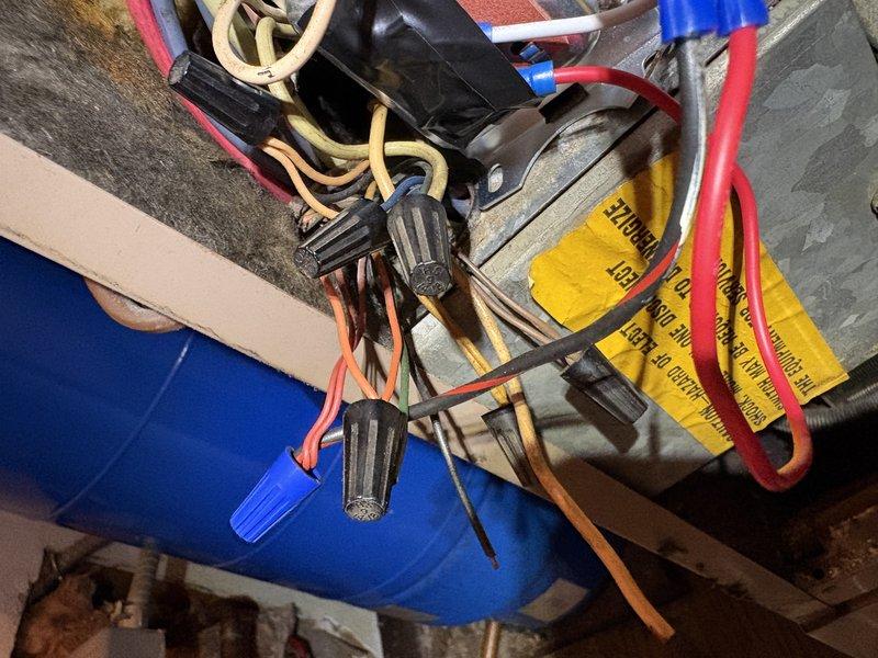 Responded to no-cooling call on Goodman air conditioning system over 10 years old. Upon arrival, found unit experiencing power and thermostat communication issues. Inspected outdoor condenser unit and traced electrical connections to attic junction point. Identified loose wire connections at thermostat wiring junction causing intermittent power loss to system. Secured all wire connections, verified proper voltage at thermostat and condenser unit, and tested system operation through complete cooling cycle. Unit restored to normal operation with proper thermostat control and full cooling capacity.