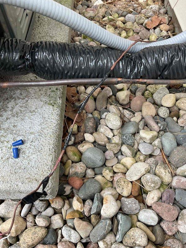 Responded to no-cool condition on 4-year-old EnergiAir system. Upon arrival, inspected outdoor condenser unit and associated refrigerant lines. Documented existing installation showing flexible ductwork and refrigerant line set routing through landscaped area with river rock ground cover. Identified service issue, performed necessary repairs to restore cooling operation. System tested and verified operational before departure.