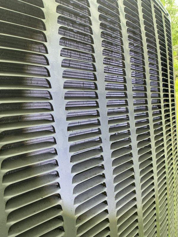 Completed annual cooling system maintenance and inspection on outdoor HVAC unit. Performed comprehensive tune-up including cleaning of condenser coils and louver panels, removing accumulated debris such as leaves and organic material from grille openings and exterior surfaces. Inspected condenser fins, verified proper airflow through ventilation slats, and assessed overall unit condition. Equipment operating within normal parameters following service. Customer requested scheduling of furnace tune-up to be completed at earliest available appointment.