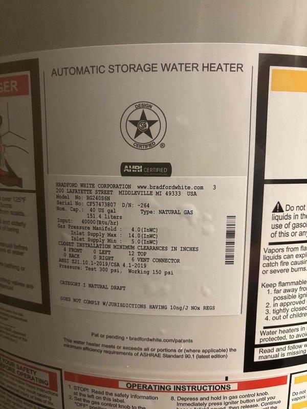 Replaced existing 50-gallon water heater with new Bradford White 40-gallon short natural gas water heater (Model BW246SN, Serial CFS7473807) installed in basement utility room beneath existing water tank. Unit features 40,000 BTU/hr input rating with 6-inch vent connector and meets ANSI Z21.10.1-2015 standards for closet installation clearances. Connected copper supply and discharge piping with brass fittings to integrate with existing plumbing system. Verified proper gas pressure settings, tested all connections for leaks, and confirmed unit operation according to manufacturer specifications.