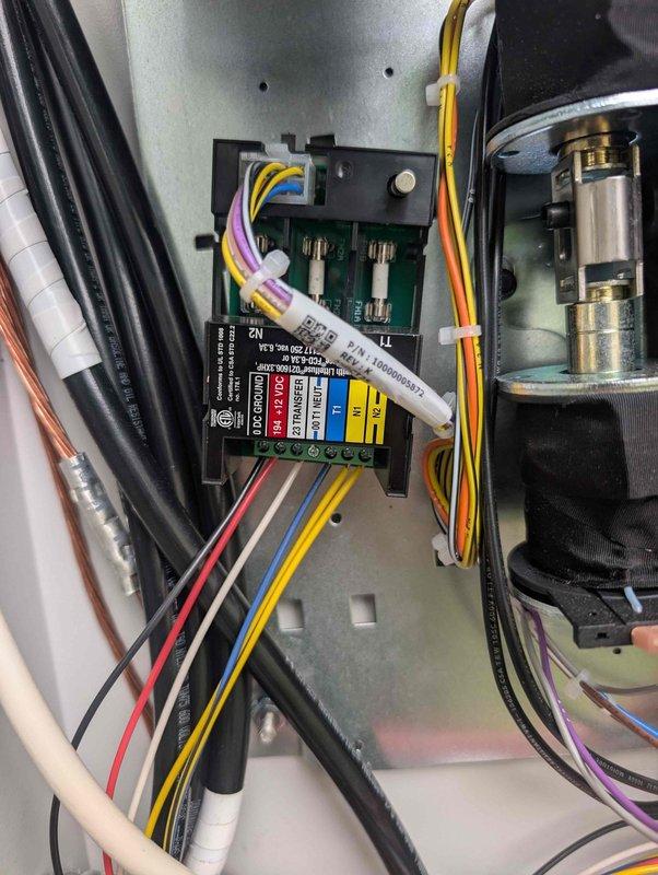 Responded to generator battery charging alert. Technician inspected electrical connections and control panel wiring to diagnose charging system failure. Examined terminal blocks, wire connections, and control module components. Documented existing conditions with photos showing terminal block assembly with multiple colored wire connections and control panel interior containing electrical module with fuse protection and various circuit connections. Investigation revealed potential issues with battery charging circuit requiring further evaluation upon return visit.