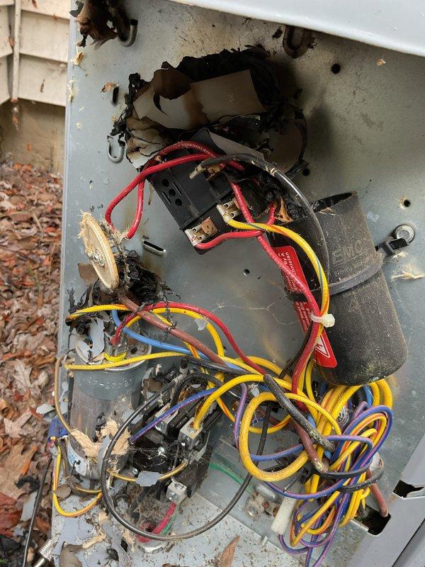 Responded to service call for annual cooling maintenance on 2011 Carrier unit. Upon arrival, discovered extensive electrical fire damage within the outdoor unit's control panel. Heavy soot, charring, and heat damage observed throughout the enclosure, with burn patterns indicating fire originated in the upper-center section of the control panel. Multiple electrical wires showed melting and heat damage, including red, yellow, blue, purple, and green conductors. Capacitor and associated wiring connections exhibited severe burn damage and compromised insulation. Metal housing displayed warping and discoloration from heat exposure.

Documented damage with photographs for insurance and warranty purposes. Unit deemed unsafe for operation due to compromised electrical components and fire hazard. Disconnected power to prevent further damage or safety risks. Recommended complete replacement of outdoor unit's electrical control assembly, including contactor, capacitor, wiring harness, and control