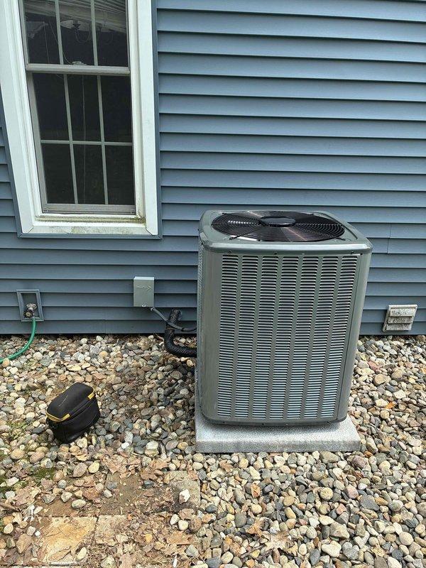 Complete HVAC system replacement performed, including installation of new air conditioning condenser unit and indoor air handler. Outdoor condenser unit positioned on concrete pad with proper gravel base for drainage and stability, with refrigerant lines and electrical connections properly installed. Indoor evcon air handler installed in basement utility area with connections to existing ductwork system, including proper integration with supply and return plenums. All electrical connections, refrigerant lines, and condensate drainage systems installed per manufacturer specifications and local code requirements. System tested and verified operational upon completion.