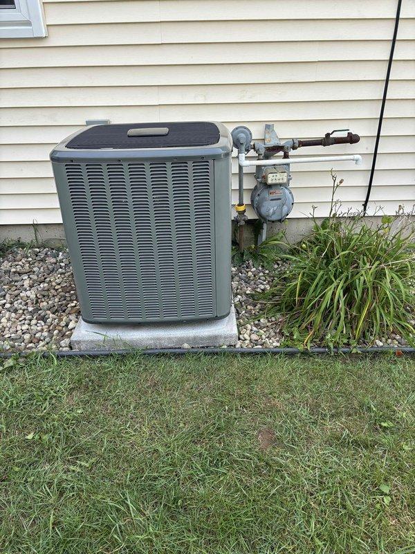 Completed full air conditioning system replacement at residential property. Removed existing outdoor condensing unit and installed new unit on concrete pad with proper leveling and positioning adjacent to exterior wall. Established refrigerant connections and performed system charging procedures using manifold gauges to verify proper pressures across all refrigerant lines. Verified electrical connections to outdoor disconnect and confirmed proper voltage supply. Conducted system startup and operational testing to ensure proper compressor function, airflow through condenser coil, and overall system performance within manufacturer specifications.