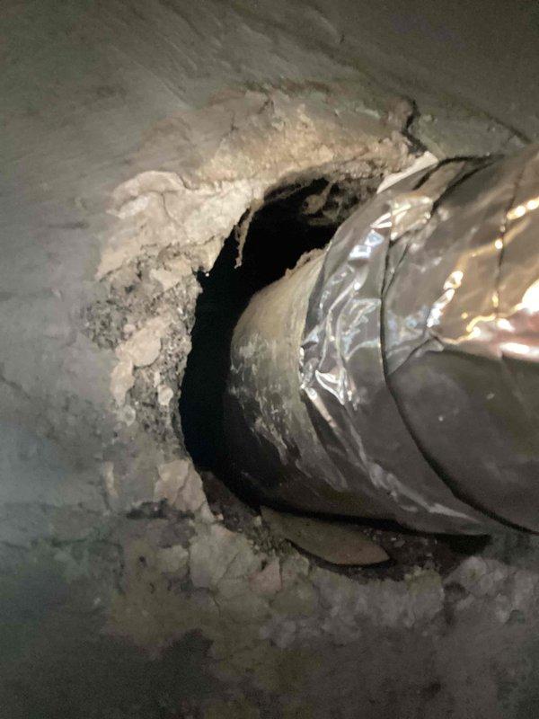 Completed annual cooling maintenance on 6-year-old Luxaire system. Performed comprehensive tune-up including inspection of ductwork, connections, and insulation integrity. Documented existing flexible duct penetration through ceiling structure and supply duct configuration in basement area showing proper insulation and condensation management on cold surfaces.