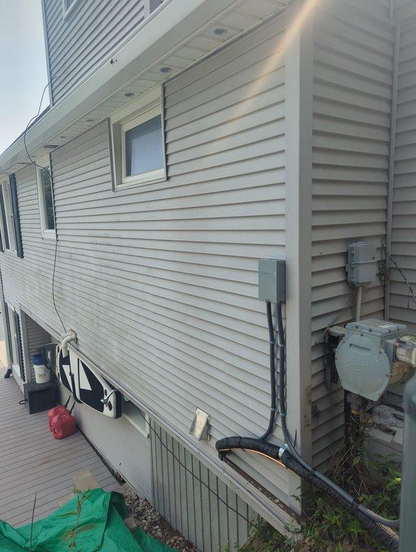 Completed full air conditioning system replacement at lakefront residential property. Installed new outdoor condenser unit on concrete pad adjacent to building exterior, establishing proper clearances and securing all electrical connections through existing conduit infrastructure. Verified system operation, refrigerant charge, and airflow parameters to manufacturer specifications upon completion.
