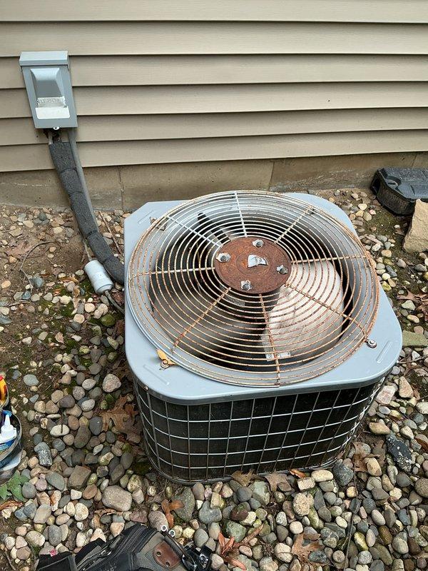 Completed annual cooling maintenance on a 2021 Carrier air conditioning system. Performed comprehensive inspection of outdoor condenser unit, noting significant rust deterioration on fan guard requiring future attention, and inspected indoor air handler components. All system operations verified and photographic documentation captured for service records.