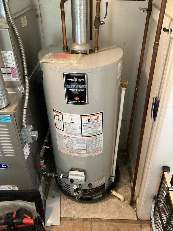 Responded to service call for Bradford White Defender Safety System water heater with pilot light failure and red flashing indicator during ignition attempts. Inspected approximately 10-year-old unit, diagnosed ignition system malfunction, and successfully restored pilot light operation. Water heater returned to normal functioning with all safety systems operational.