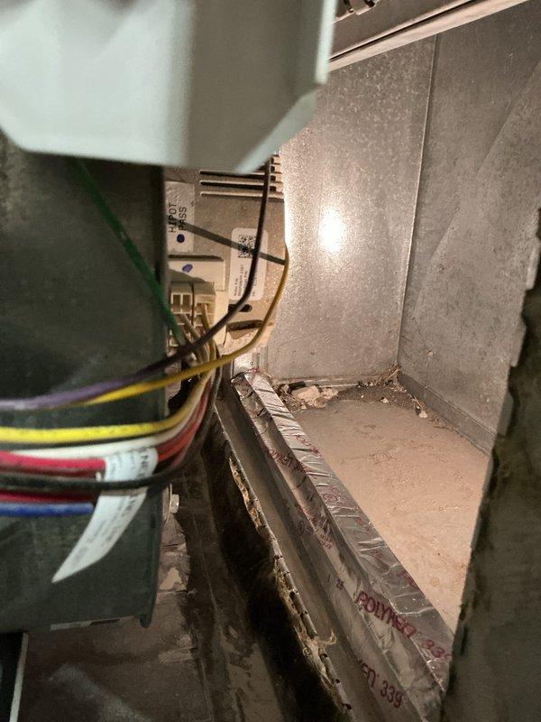 Completed annual cooling maintenance on a 4-year-old air conditioning system. Performed comprehensive tune-up including inspection of air handler components, electrical connections, and blower assembly. Verified proper operation of control board and wiring harness with multiple conductors. Inspected interior cabinet and ductwork connections. Documented equipment condition with photos showing accessible components including electrical module, wire bundles secured with cable ties, and metallic plenum assembly. System operational and ready for cooling season.
