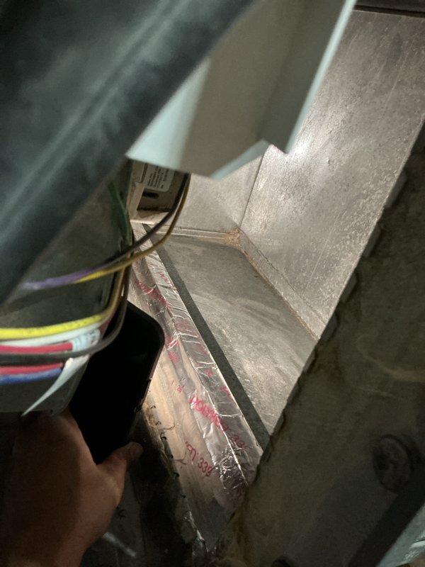 Completed annual cooling maintenance on a 4-year-old air conditioning system. Performed comprehensive tune-up including inspection of air handler components, electrical connections, and blower assembly. Verified proper operation of control board and wiring harness with multiple conductors. Inspected interior cabinet and ductwork connections. Documented equipment condition with photos showing accessible components including electrical module, wire bundles secured with cable ties, and metallic plenum assembly. System operational and ready for cooling season.