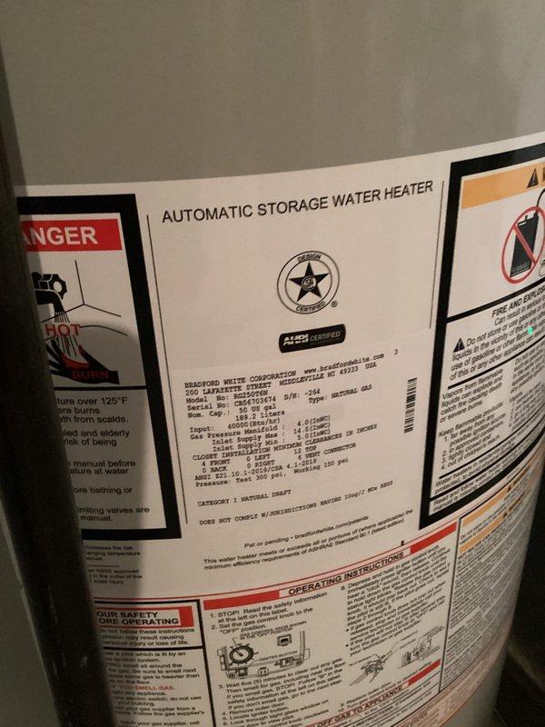 Completed installation of automatic storage water heater with new copper piping connections in basement mechanical room. Unit was properly positioned, connected to existing gas and water lines with appropriate brass fittings, and tested for proper operation alongside existing HVAC furnace system.
