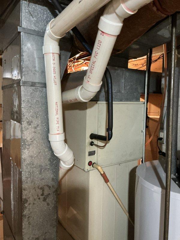 Responded to a no-cooling complaint on a 16-year-old air conditioning system where the outdoor compressor fan was not running while the indoor blower continued to operate. Upon arrival, performed diagnostic evaluation of the Weathermaker HVAC system and documented the existing equipment configuration, including the furnace unit with PVC venting and copper refrigerant lines. Discussed replacement options for both the aging air conditioner and the similarly-aged furnace system with the customer, providing estimate for new equipment installation.