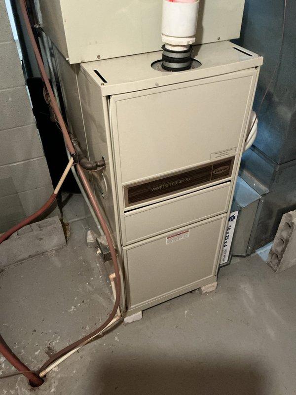 Responded to a no-cooling complaint on a 16-year-old air conditioning system where the outdoor compressor fan was not running while the indoor blower continued to operate. Upon arrival, performed diagnostic evaluation of the Weathermaker HVAC system and documented the existing equipment configuration, including the furnace unit with PVC venting and copper refrigerant lines. Discussed replacement options for both the aging air conditioner and the similarly-aged furnace system with the customer, providing estimate for new equipment installation.