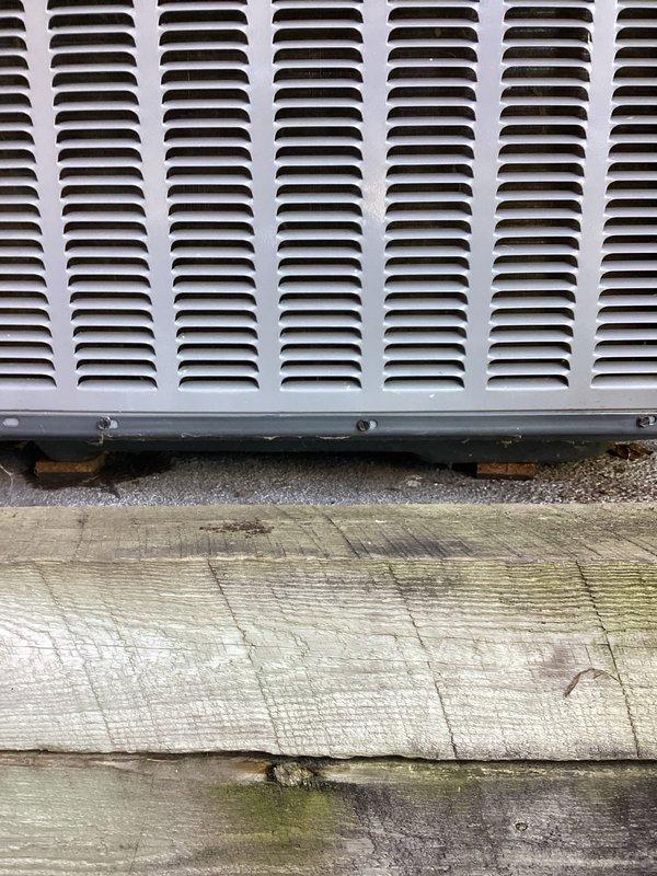 Leveled exterior condenser unit using landscaping materials to ensure proper positioning and operation. Unit was assessed for plumb and level conditions, with adjustments made to stabilize the equipment on its pad. Work completed under warranty coverage.