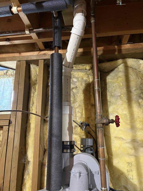 Completed estimate for water heater replacement in single family home. Existing 12-year-old PowerFlex water heater showing age-appropriate wear with no immediate safety concerns or operational failures reported. Inspected installation including copper supply lines, shut-off valves, metal vent pipe, and adjacent water treatment equipment. Documented current plumbing configuration with foam pipe insulation on water lines and PVC drainage system in unfinished basement area. Photographed equipment specifications, manufacturer labels, and existing connections to provide comprehensive replacement options for proactive upgrade of aging unit.