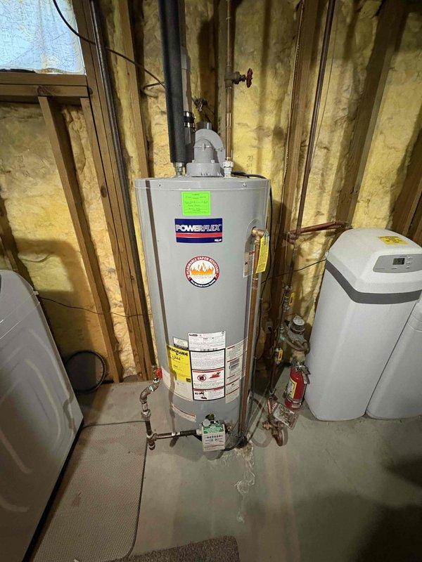 Completed estimate for water heater replacement in single family home. Existing 12-year-old PowerFlex water heater showing age-appropriate wear with no immediate safety concerns or operational failures reported. Inspected installation including copper supply lines, shut-off valves, metal vent pipe, and adjacent water treatment equipment. Documented current plumbing configuration with foam pipe insulation on water lines and PVC drainage system in unfinished basement area. Photographed equipment specifications, manufacturer labels, and existing connections to provide comprehensive replacement options for proactive upgrade of aging unit.