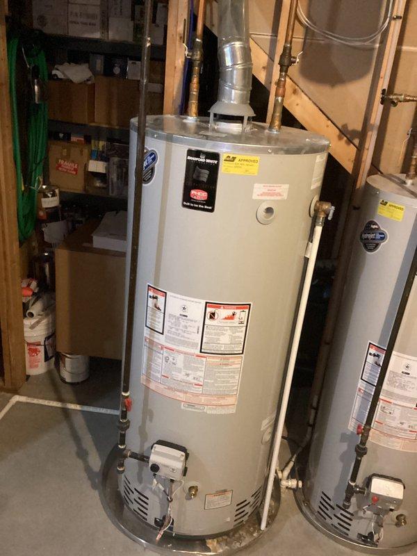 Responded to reported bathroom faucet issue requiring evaluation. Upon arrival, conducted thorough inspection of plumbing systems including water heater installation, expansion tank, and associated copper piping connections in basement utility area. Documented existing mechanical equipment configuration with Bradford White water heater system, Amtrol expansion tank, shut-off valves, and pressure relief components for maintenance records.